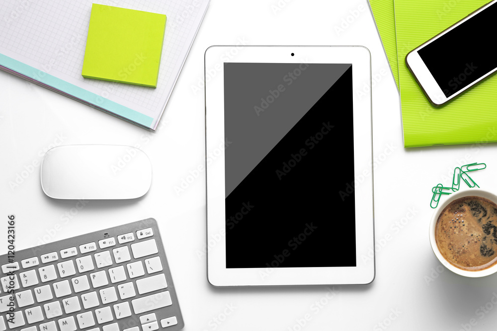 Tablet with cup of coffee and office tools on white background Tablet with cup of coffee and office tools on white background