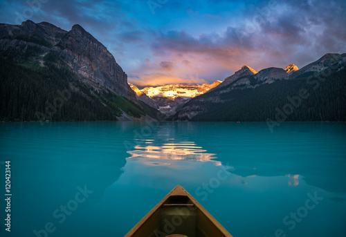 Viewing snowy mountain in rising sun from a canoe photo