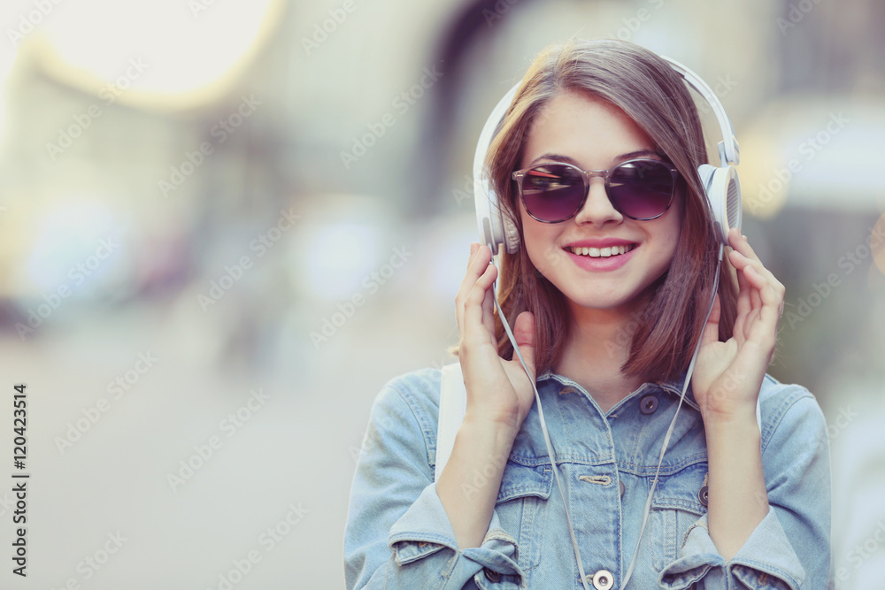 Young girl listening to music outdoors