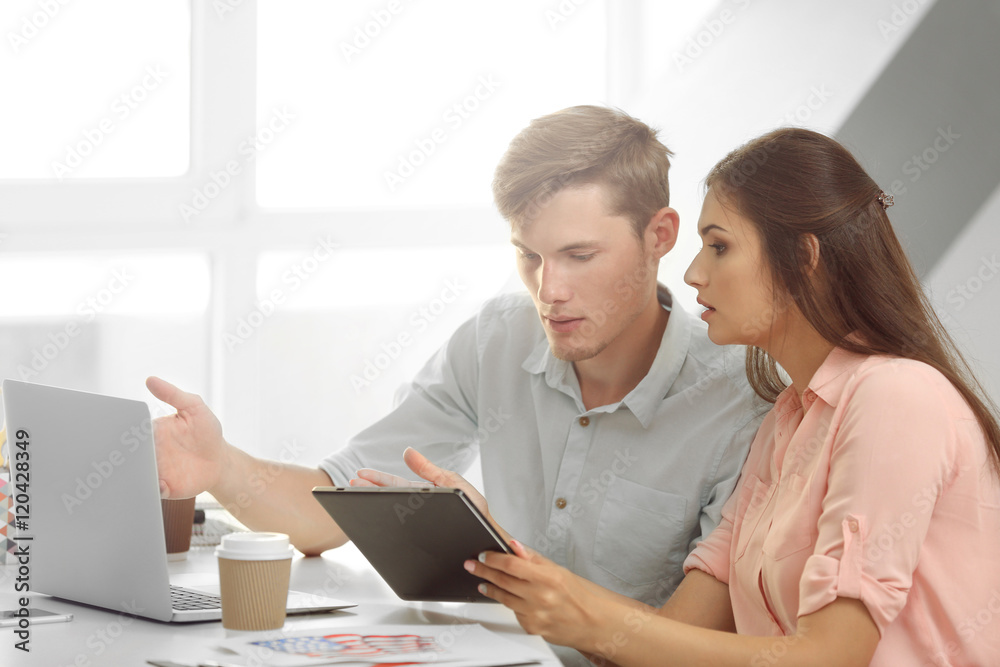 Beautiful woman with handsome man discussing business ideas in office Beautiful woman with handsome man discussing business ideas in office
