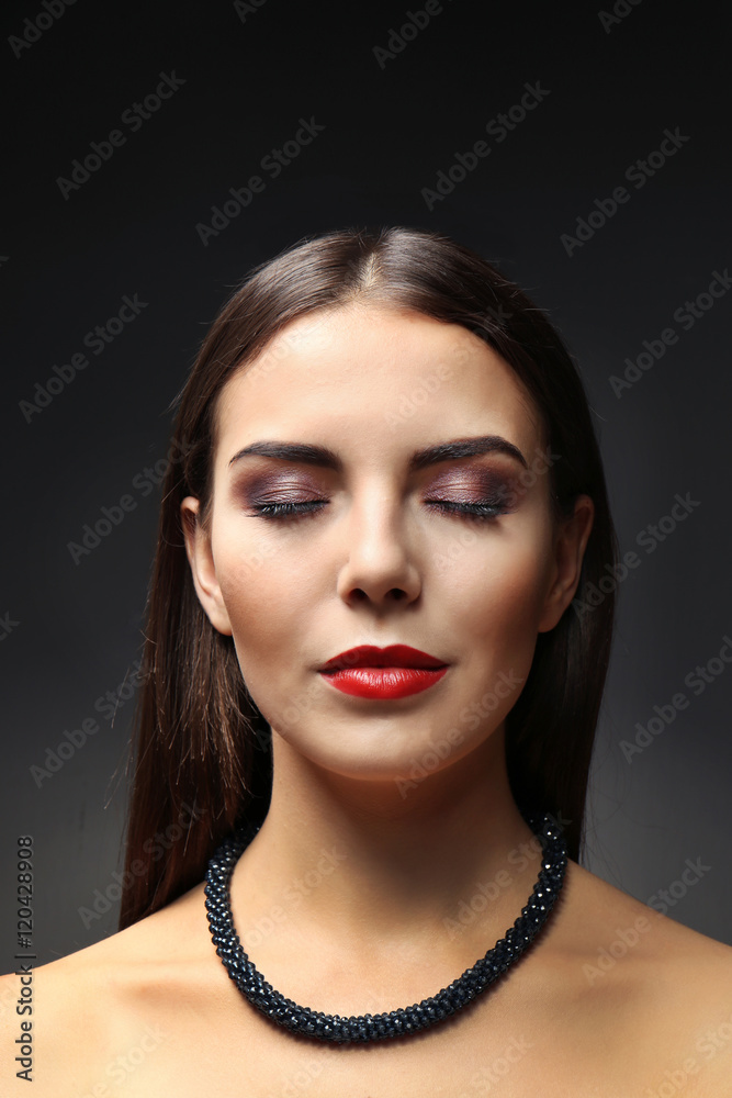 Portrait of beautiful young woman model with bright makeup on dark background Portrait of beautiful young woman model with bright makeup on dark background