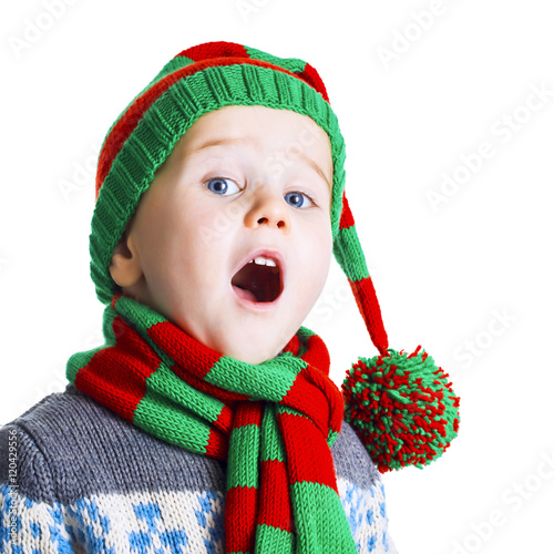 Christmas boy in knitted cloths sings a Christmas song