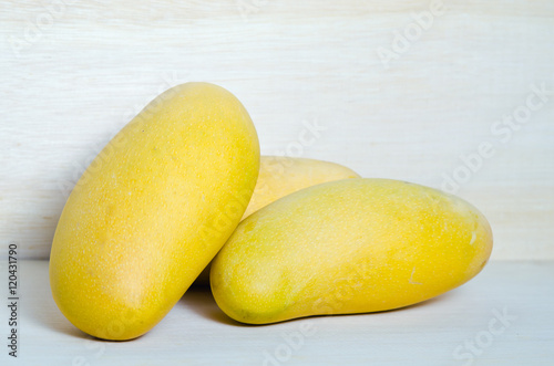 Mango on wooden background (Also known as horse mango, Mangifera photo