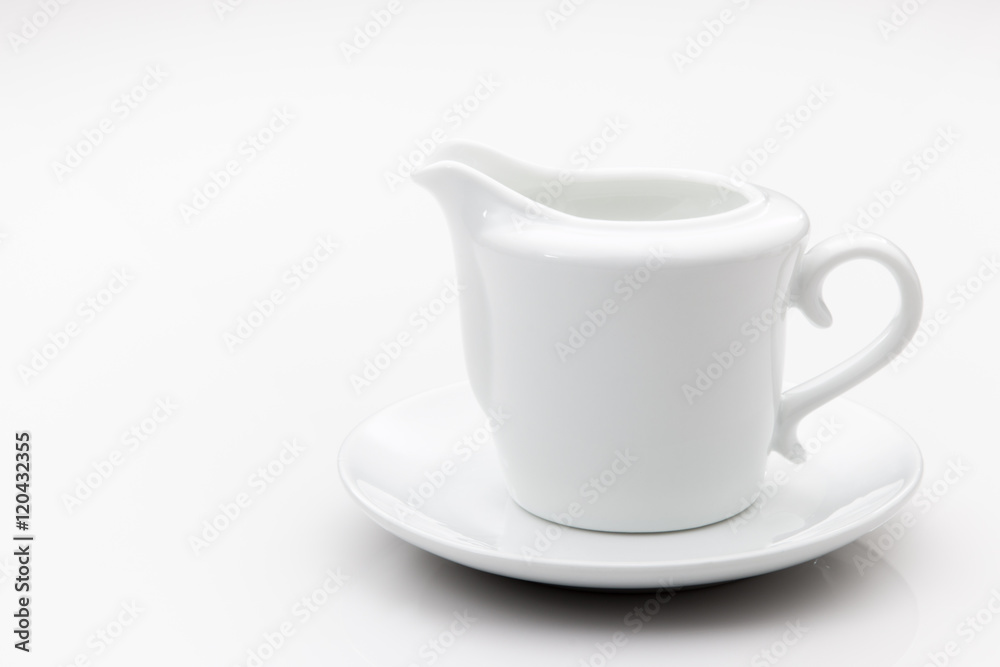 Creamer and saucer set on a white backgorund. Creamer and saucer set on a white backgorund.