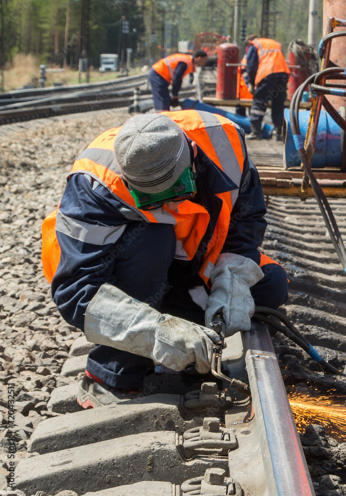 photo of worker doing gas cutting on rails photo of worker doing gas cutting on rails