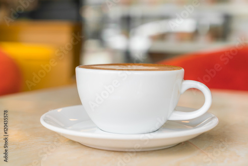 Coffee cup on table in cafe .