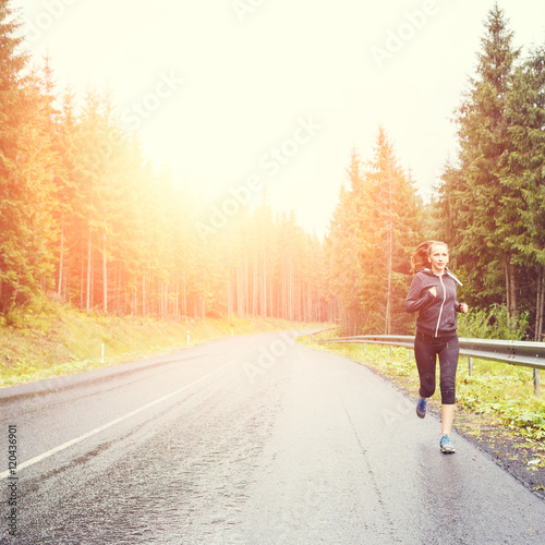 Fitness woman running at the morning in mountains.