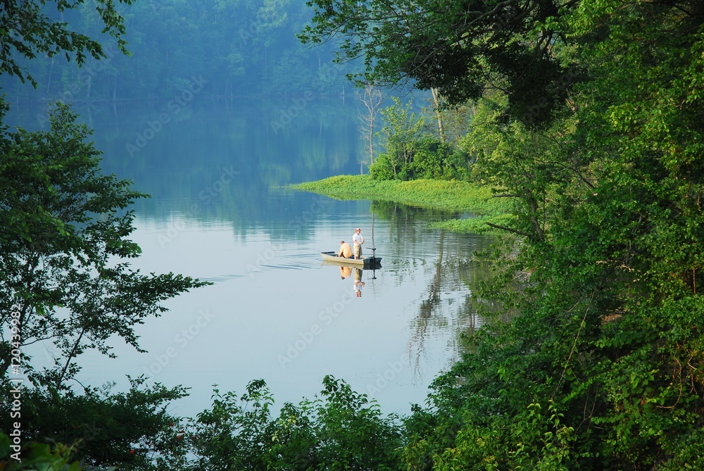 fishing on the boat in the pond in the morning