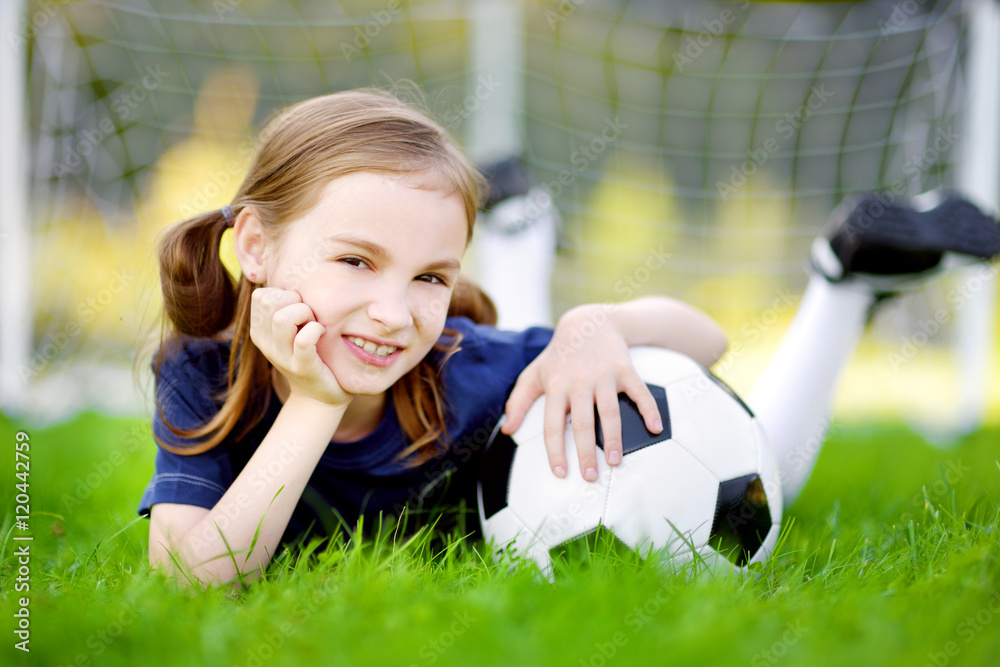 Cute little soccer player having fun playing a soccer game Cute little soccer player having fun playing a soccer game