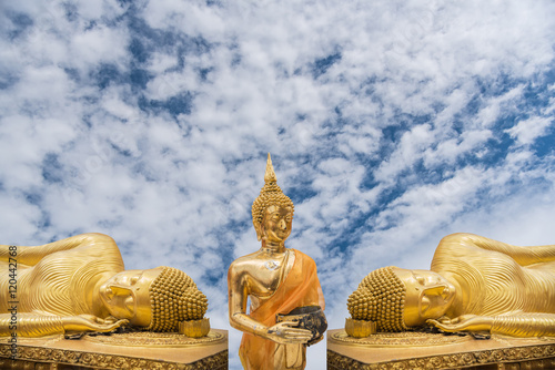 Golden Big Buddha image with blue sky background,Statue of Buddha in Thailand(have clipping path) photo