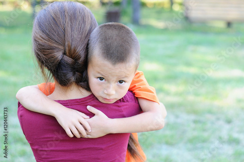 Little boy hugging mother