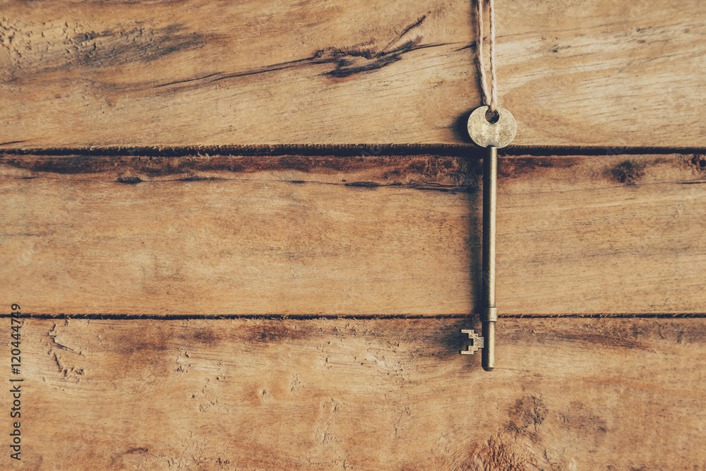 old key hanging on wood background texture with copy space old key hanging on wood background texture with copy space