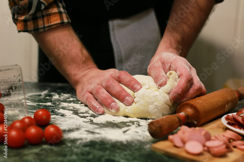 man hand prepare pizza dough topping