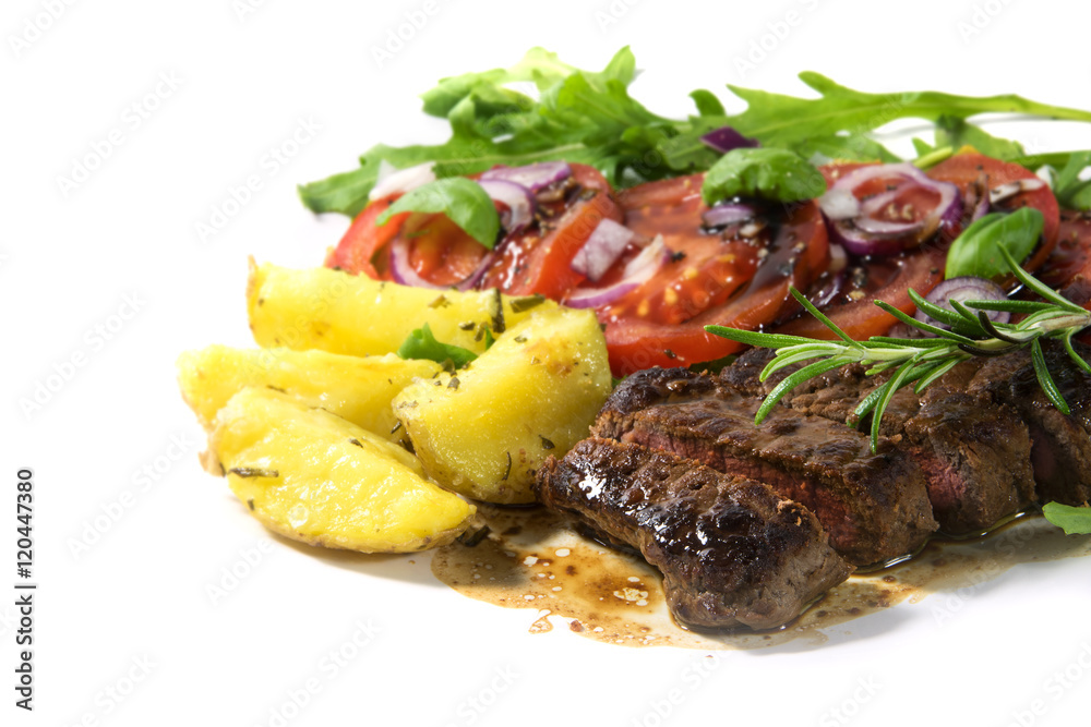 roasted beef filet mignon with potatoes and tomato arugula salad isolated on white roasted beef filet mignon with potatoes and tomato arugula salad isolated on white