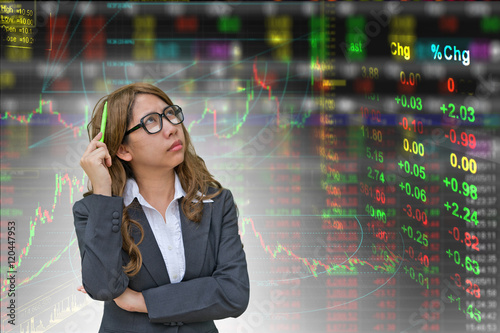  business woman thinking in stock exchange board