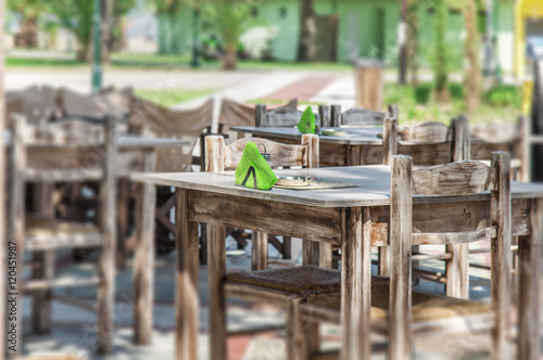 Empty restaurant tables in the Grek city