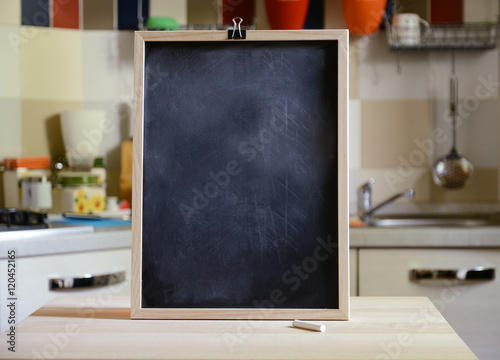blackboard on wooden table on kitchen  background