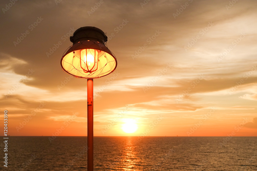 Lighting of warm lamp and lighting of sunset at sea.