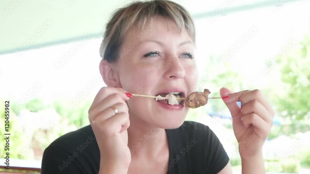 young woman eating meat