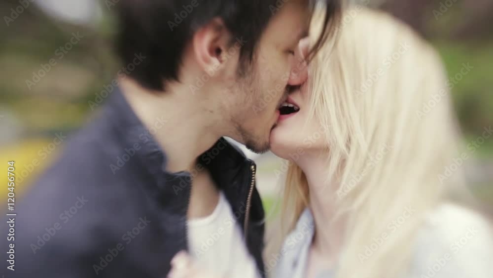 Young European couple hugging and kissing each other. Forever in love. Love is in the air. Portrait, outside shooting, windy weather. Lensbaby, close up view, slow motion. Young European couple hugging and kissing each other. Forever in love. Love is in the air. Portrait, outside shooting, windy weather. Lensbaby, close up view, slow motion.