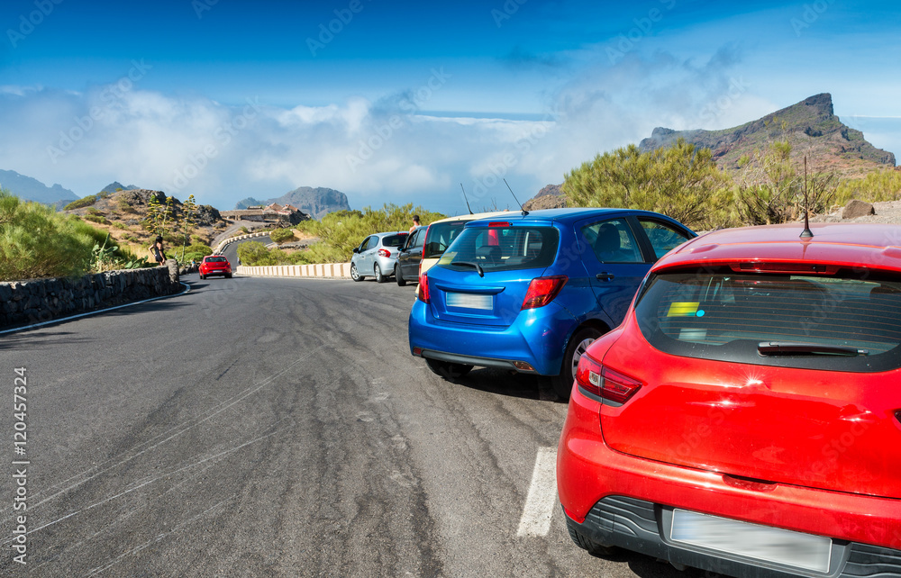 Colourful cars parked on a mountain road Colourful cars parked on a mountain road