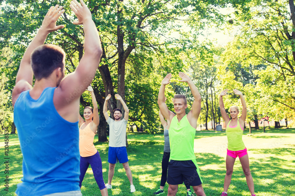 group of friends or sportsmen exercising outdoors