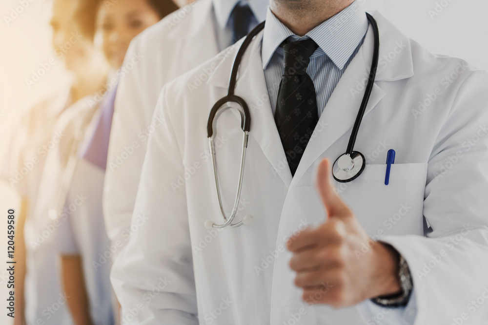 close up of happy doctor showing thumbs close up of happy doctor showing thumbs