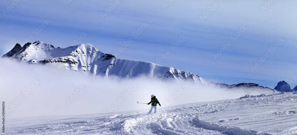 Panoramic view on snowboarder downhill on off-piste slope with n