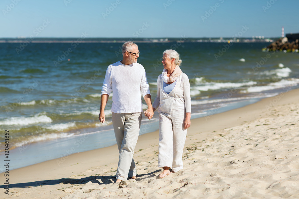 happy senior couple holding hands on summer beach happy senior couple holding hands on summer beach