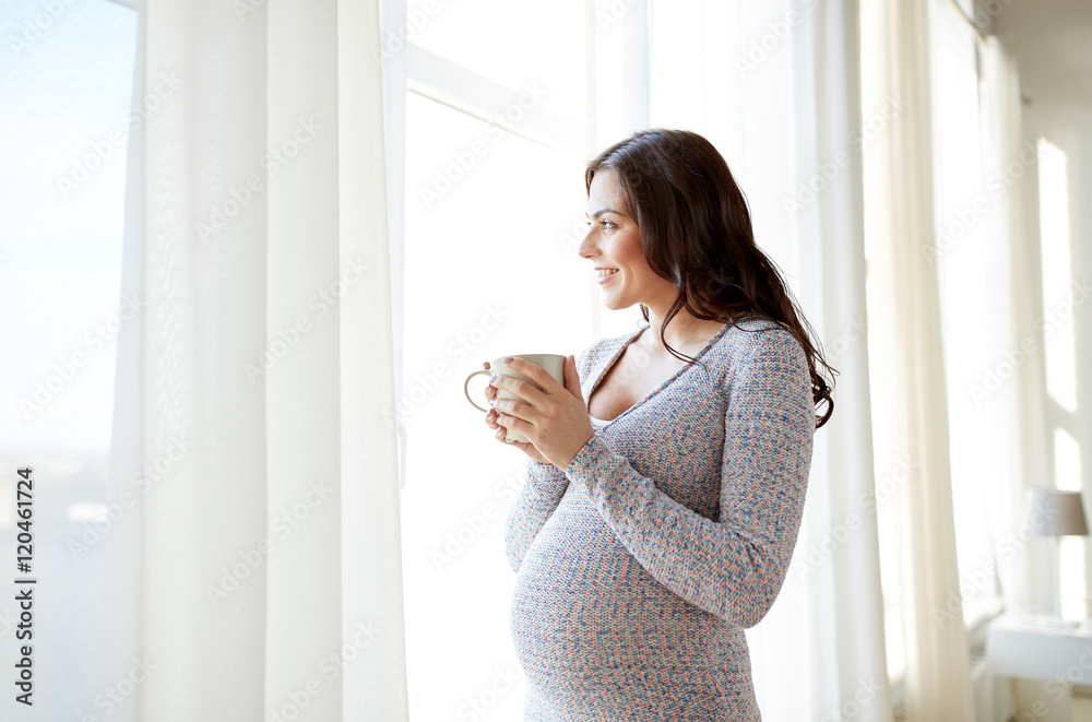 happy pregnant woman with cup drinking tea at home happy pregnant woman with cup drinking tea at home
