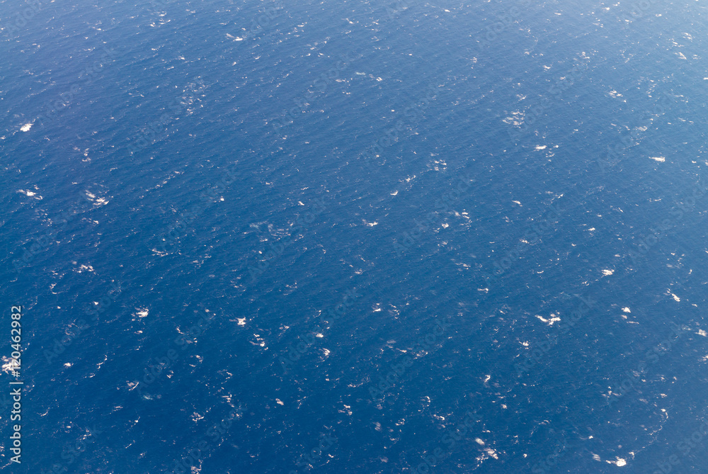 Ocean waves as seen from airplane window. Sea background Ocean waves as seen from airplane window. Sea background