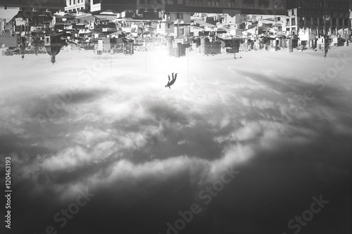 man falling from upside down city photo