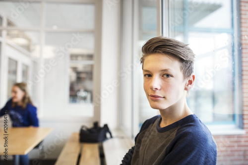 Portrait of schoolboy (12-13) looking at camera photo