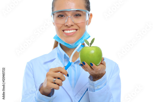 Dentist medical doctor woman hold green fresh apple in hand and tooth brush