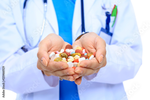 Doctor holding heap of drugs in a hand