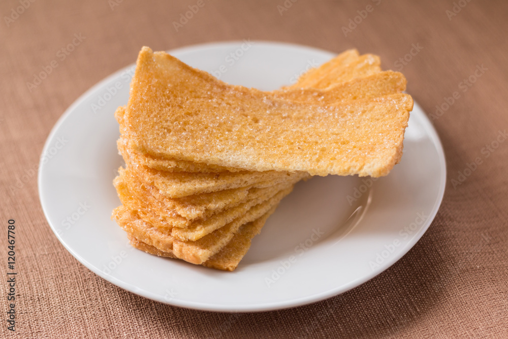 Sliced crispy bread in white ceramic dish. Sliced crispy bread in white ceramic dish.