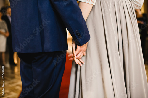 Beautiful luxury newlyweds holdind hands