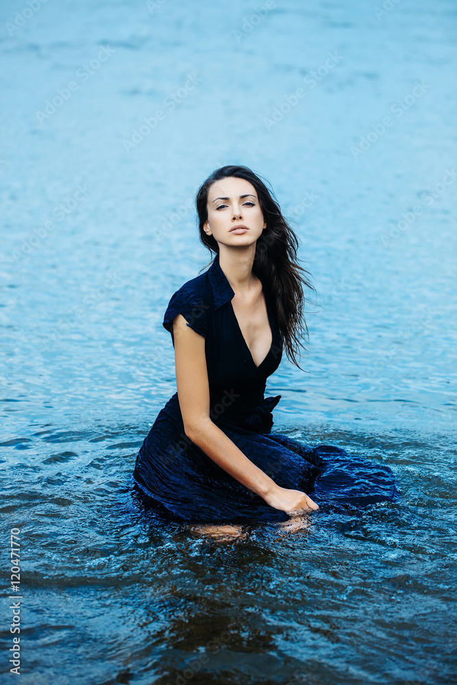 Fototapeta premium young sexy woman sitting in water