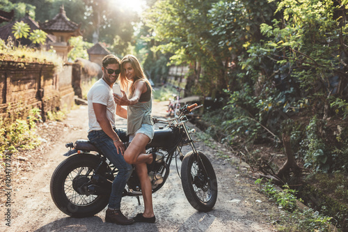 Loving young couple taking a selfie with motorcycle