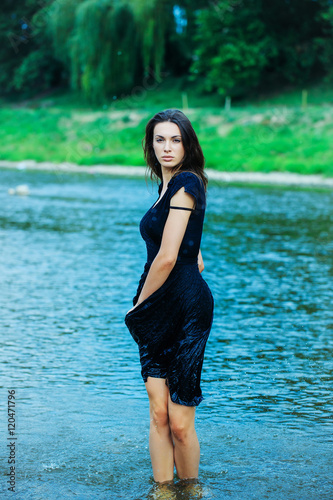 Fototapeta Naklejka Na Ścianę i Meble -  young sexy woman standing in water