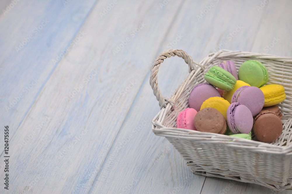 multi-colored circular cookies in a wicker basket multi-colored circular cookies in a wicker basket
