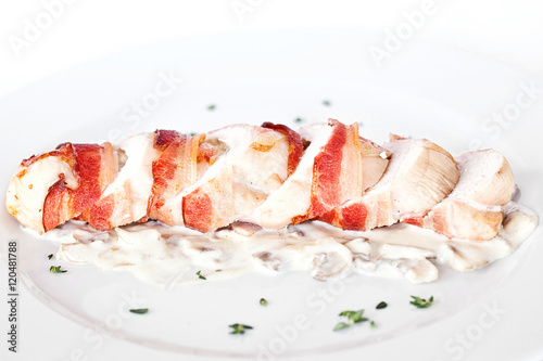 Stuffed turkey rolls with ham and spring onions in creamy sauce