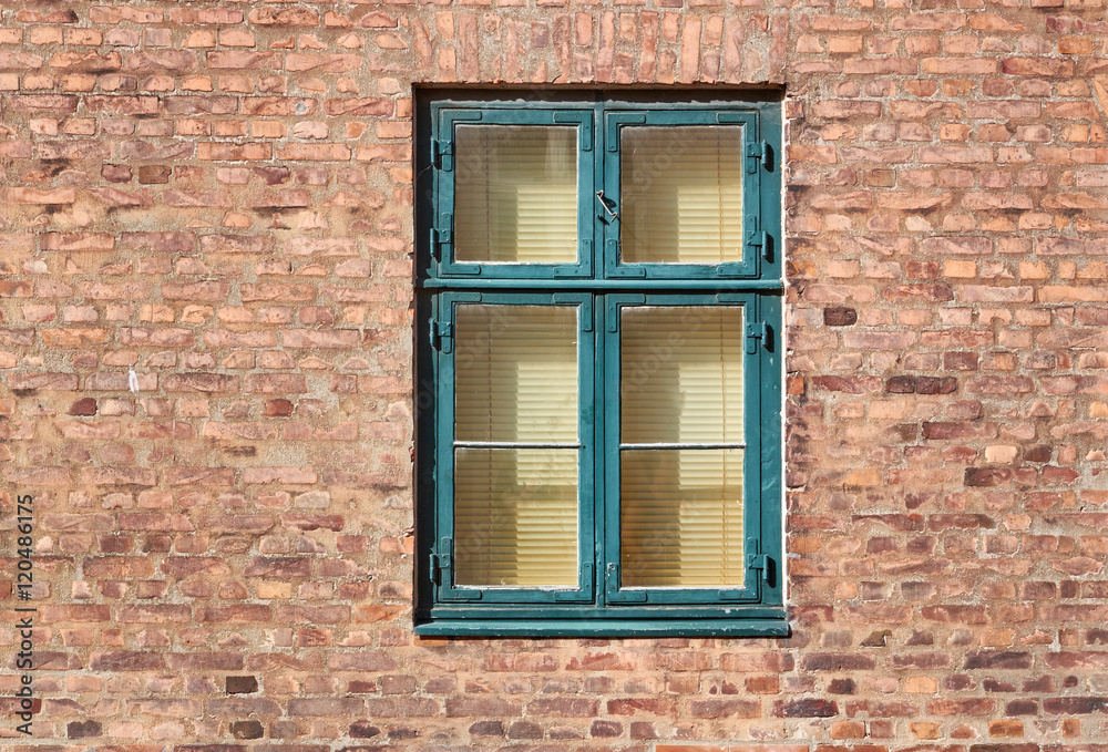 Green painted typical danish, or scandinavian style window, fastened in a red brick building facade Green painted typical danish, or scandinavian style window, fastened in a red brick building facade