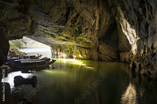 PHONG NHA/VIETNAM : JULY 16, The mouth of Phong Nha cave with underground river and taxi boats, July 16, 2016, Phong Nha National Park, Vietnam photo