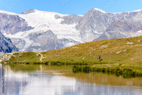 Hiker at Stellisee - beautiful lake with reflection of Matterhorn - Zermatt  Switzerland