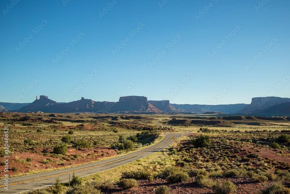 Road trip scene; long road going into scenic canyon landscape in USA