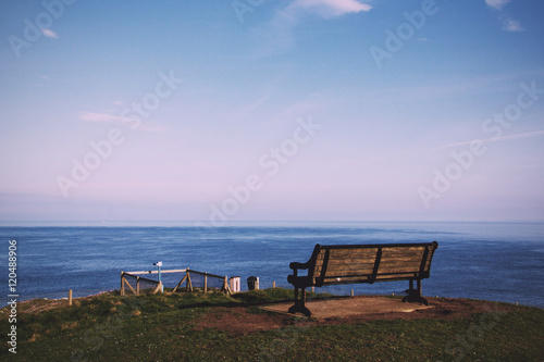  Empty bench over looking the coast in Bude, Cornwall Vintage Re