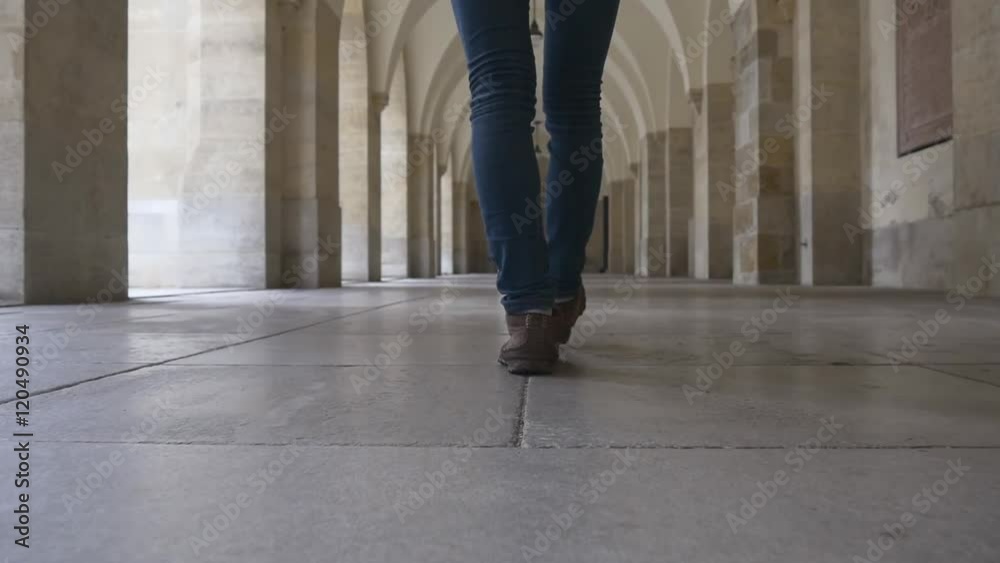 Women's feet go through the hall of columns Women's feet go through the hall of columns