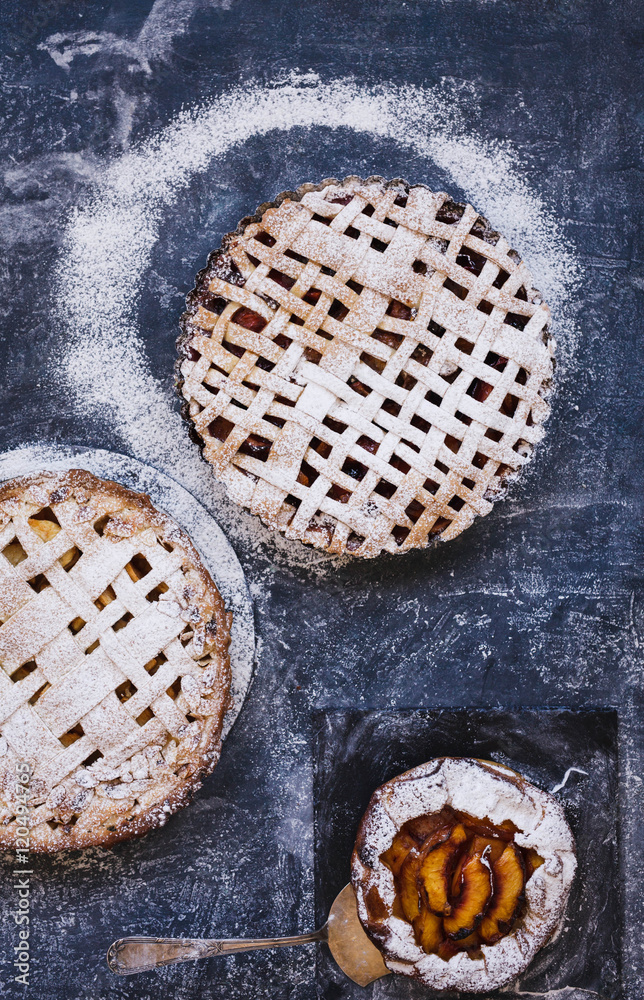 Fruit pie crust and fruit galette over blue flourish table. Fruit pie crust and fruit galette over blue flourish table.