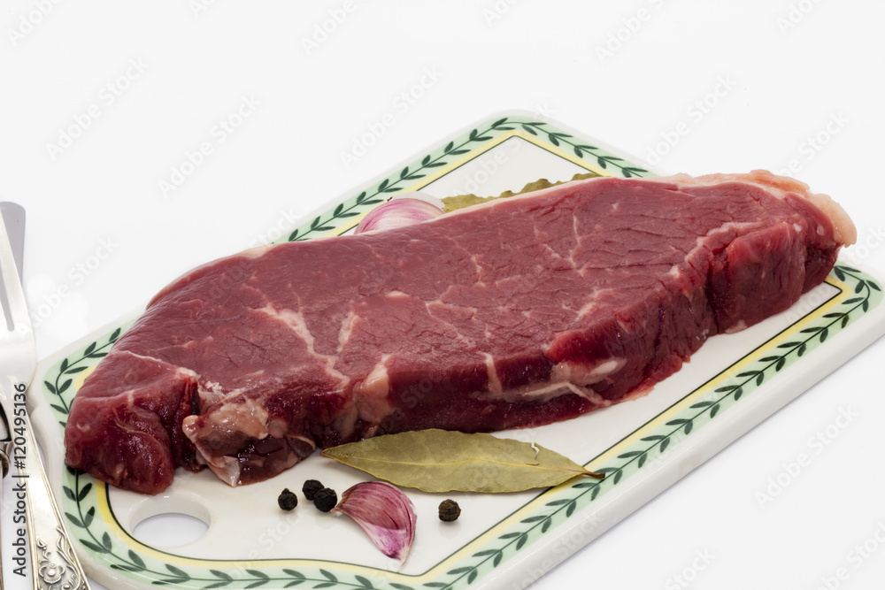 Sirloin steak on a ceramic board.